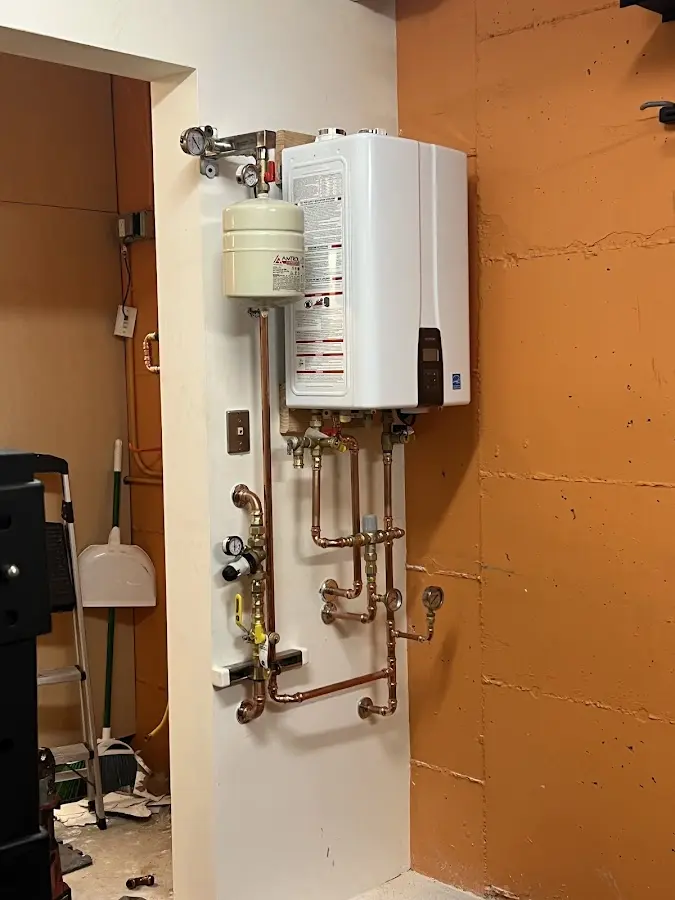 Plumbing technician inspecting water heater connections in Ellenton